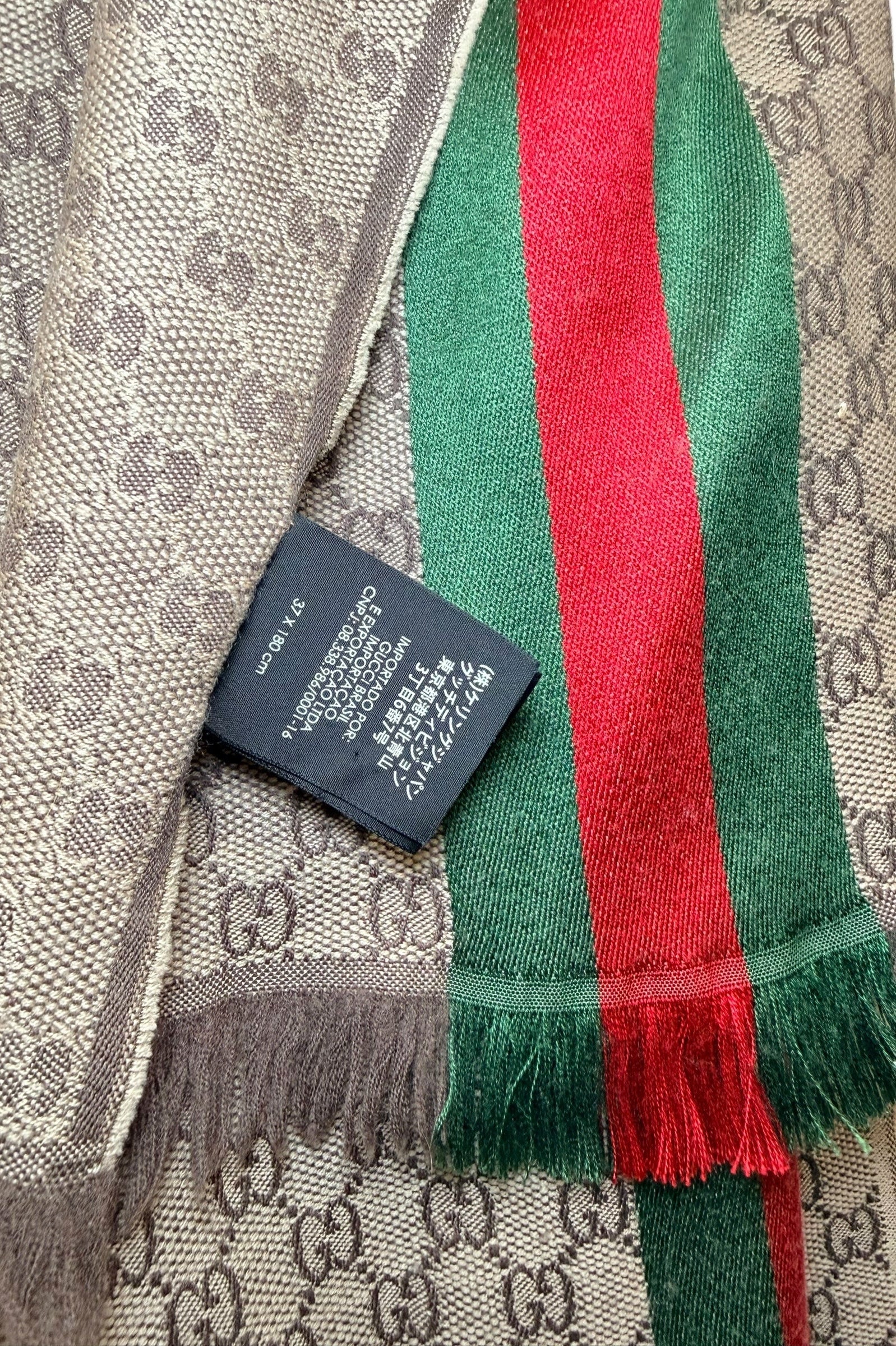 Gucci GG monogram scarf care label with material composition and Italian manufacture