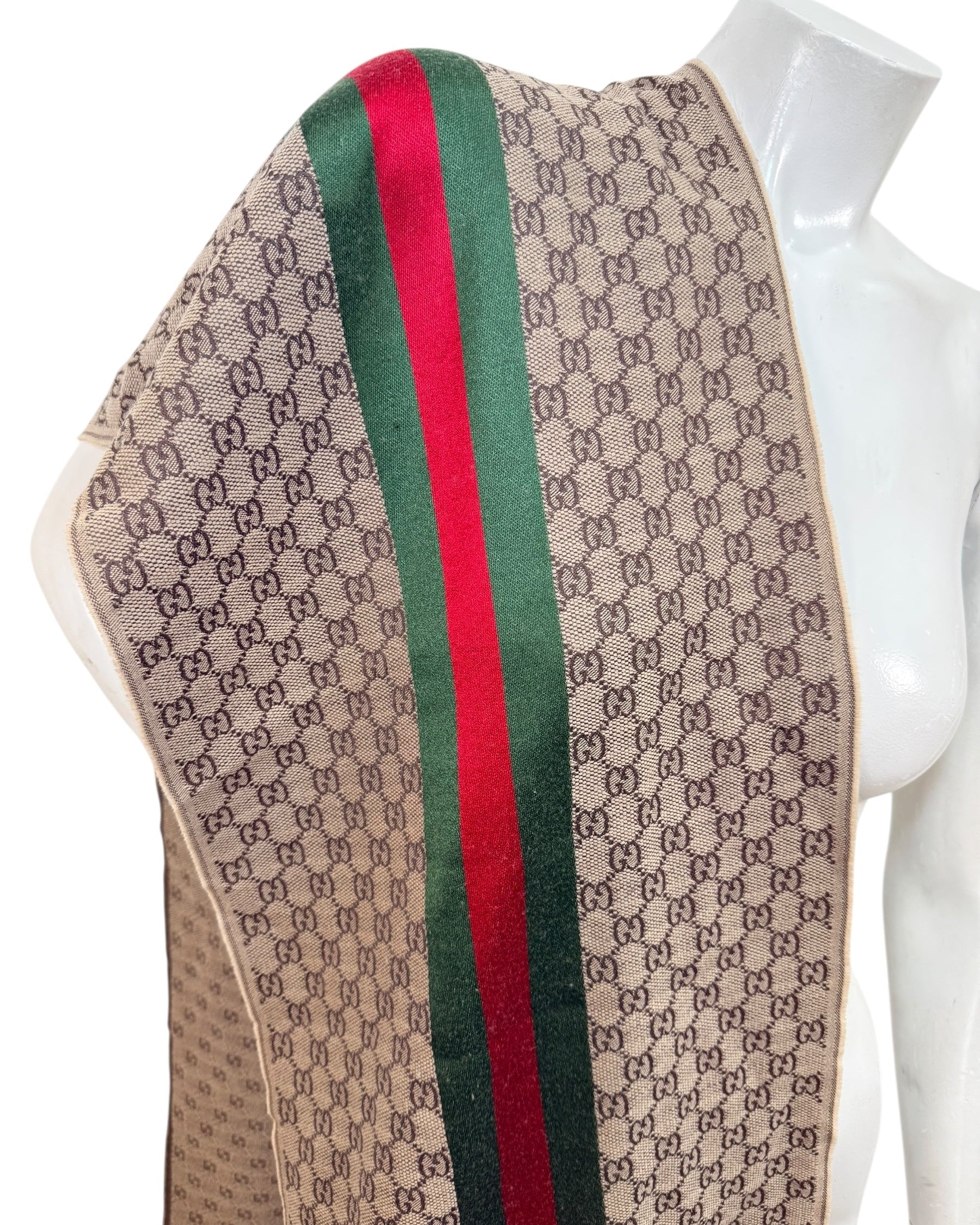 Close-up of Gucci GG monogram fabric with green red web stripe and woven wool silk texture
