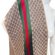 Close-up of Gucci GG monogram fabric with green red web stripe and woven wool silk texture