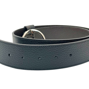 Rolled display of Gucci black leather Interlocking G belt with silver GG buckle, luxury designer accessory from Alessandro Michele era.