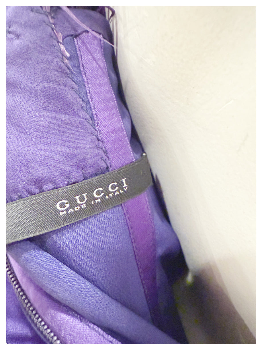 Interior Gucci label reading “Gucci Made in Italy” inside purple evening gown.