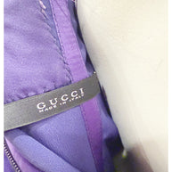 Interior Gucci label reading “Gucci Made in Italy” inside purple evening gown.