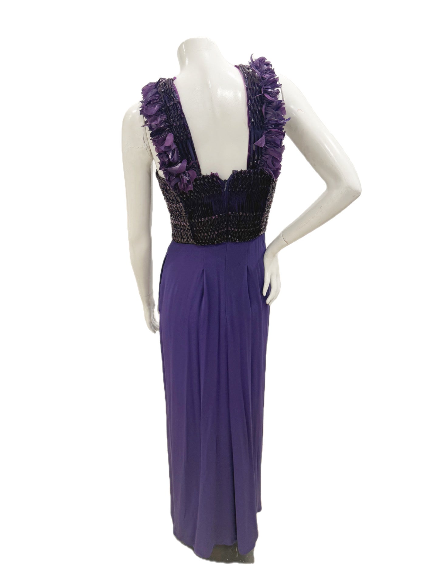 Back view of Gucci purple evening gown with feather-trim straps and flowing skirt.
