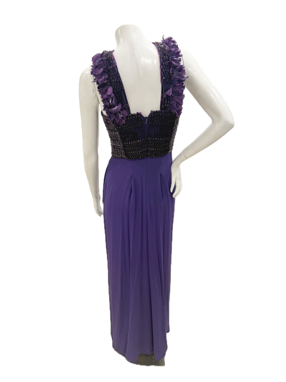 Back view of Gucci purple evening gown with feather-trim straps and flowing skirt.