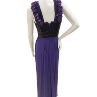 Back view of Gucci purple evening gown with feather-trim straps and flowing skirt.