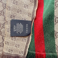 Gucci scarf authenticity label showing made in Italy tag and GG monogram fabric