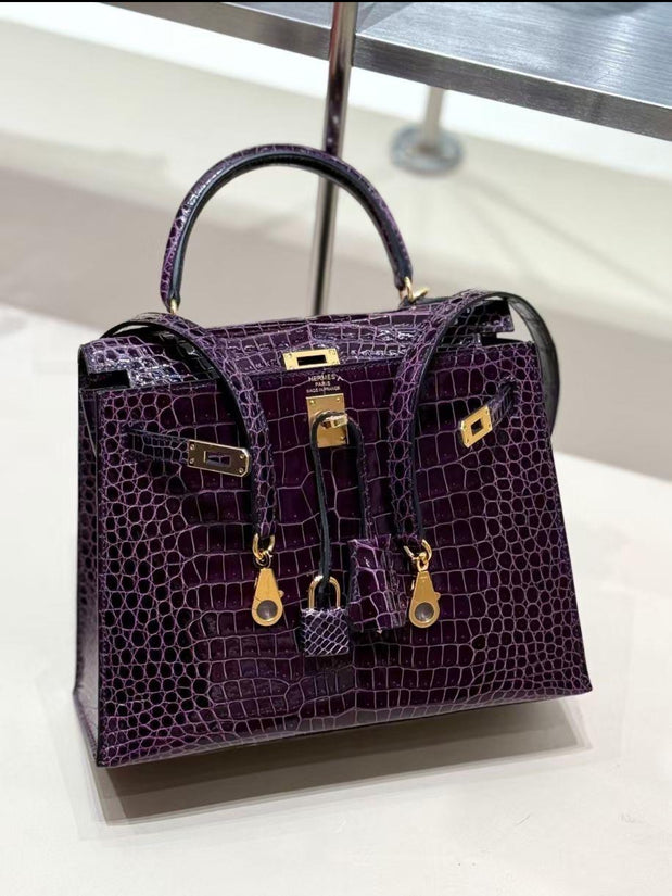 Hermes Purple crocodile skin 30 cm Birkin handbag with gold hardware on a white background