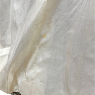 Close-up of Chanel Spring 1996 silk CC jacquard lining showing light interior spot and gold-tone chain hem detail