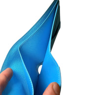 Close-up of interior compartment of Louis Vuitton SS23 Comics Wallet showing blue leather lining and stitching detail.