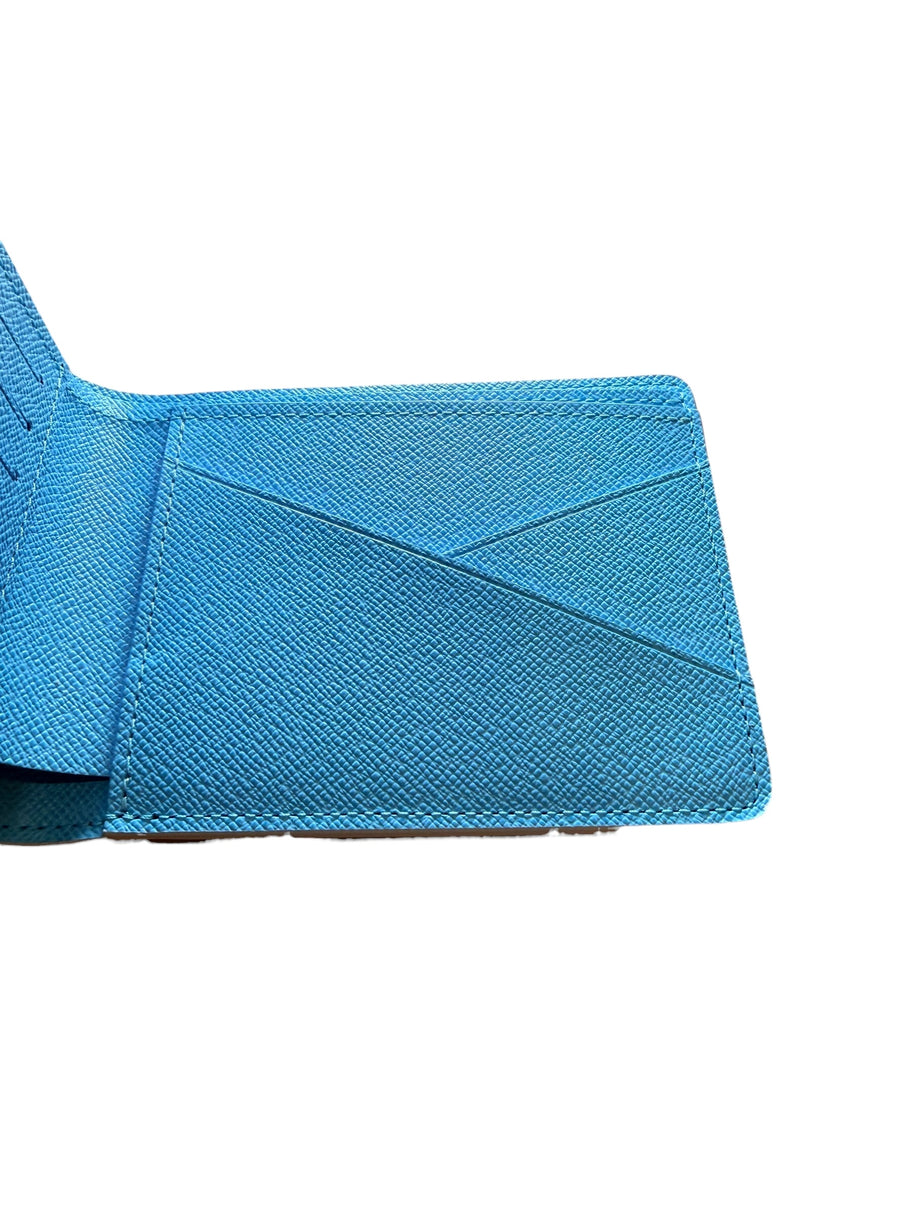 Detailed view of interior panel of Louis Vuitton SS23 Comics Wallet featuring blue textured leather and card slots.