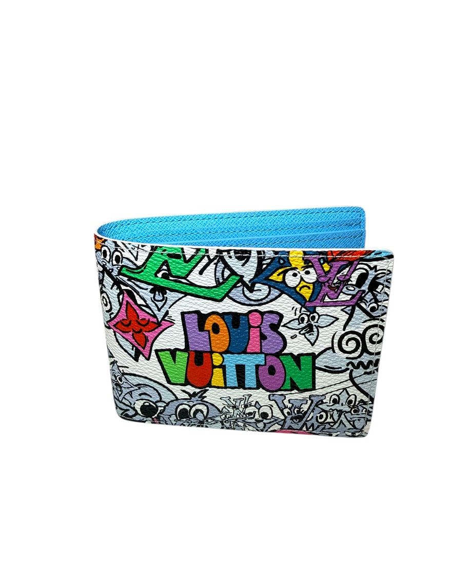 Louis Vuitton SS23 Comics Wallet photographed at angle revealing vibrant print and blue leather interior.