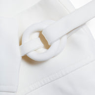 Close-up of the Louis Vuitton white mini skirt’s sculptural fabric-covered ring fastening from the Spring/Summer 2019 collection.
