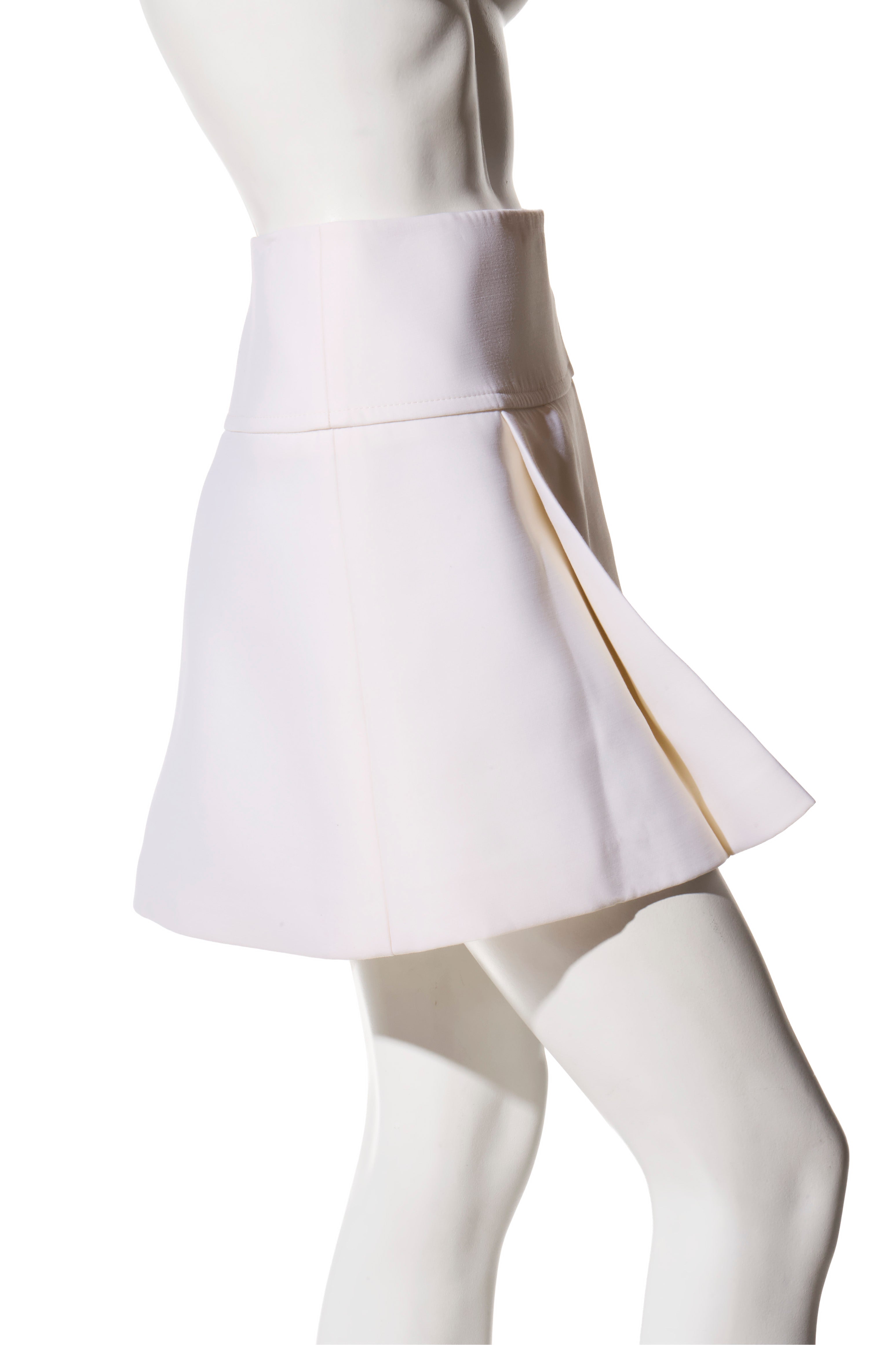 Side angle of the Louis Vuitton SS19 white high-waisted mini skirt, highlighting the structured A-line shape and clean pleat construction.