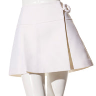 Front view of the Louis Vuitton Spring/Summer 2019 white mini skirt in size FR 36, showing the high-waisted A-line silhouette and sculptural ring fastening detail.