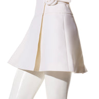 Right side view of the Louis Vuitton SS19 white mini skirt showcasing the signature fabric-covered ring fastening and crisp architectural lines.