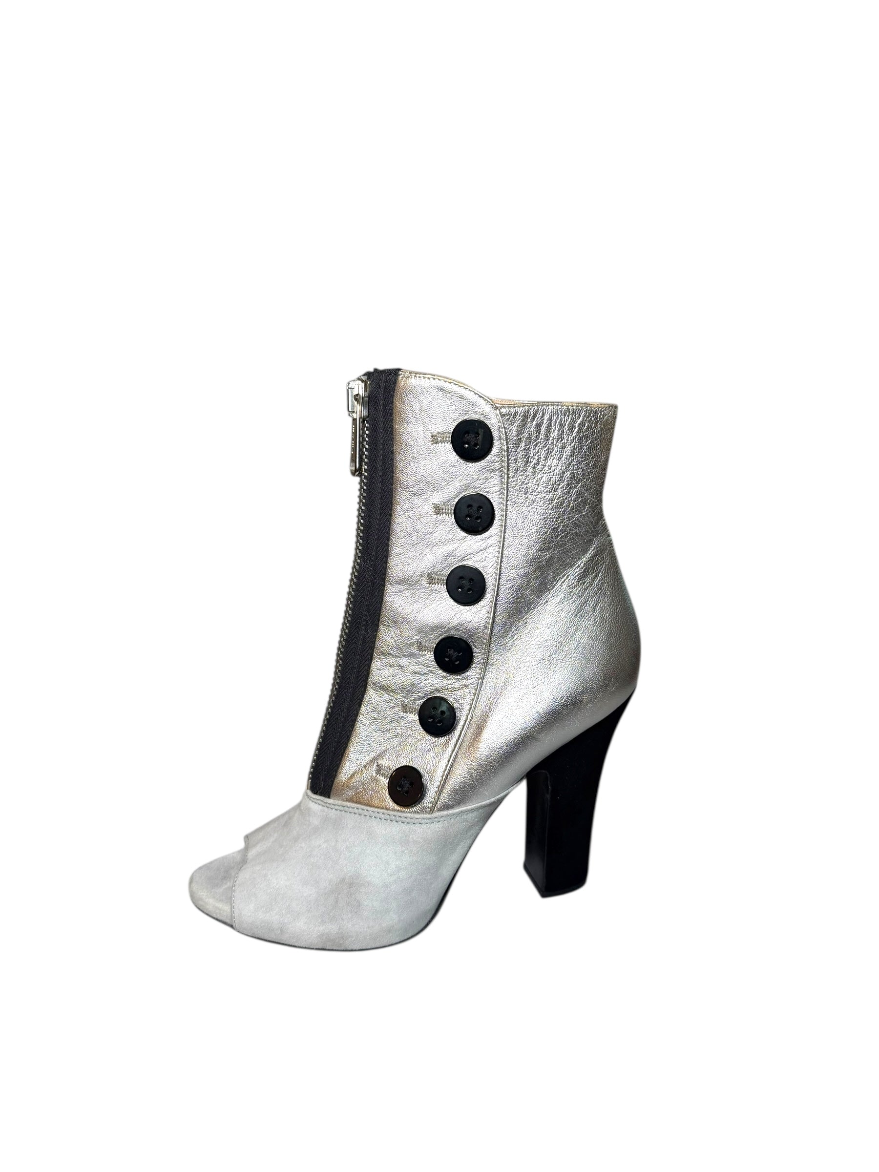 Silver Miu Miu left outside view of ankle bootie with black buttons on a white background