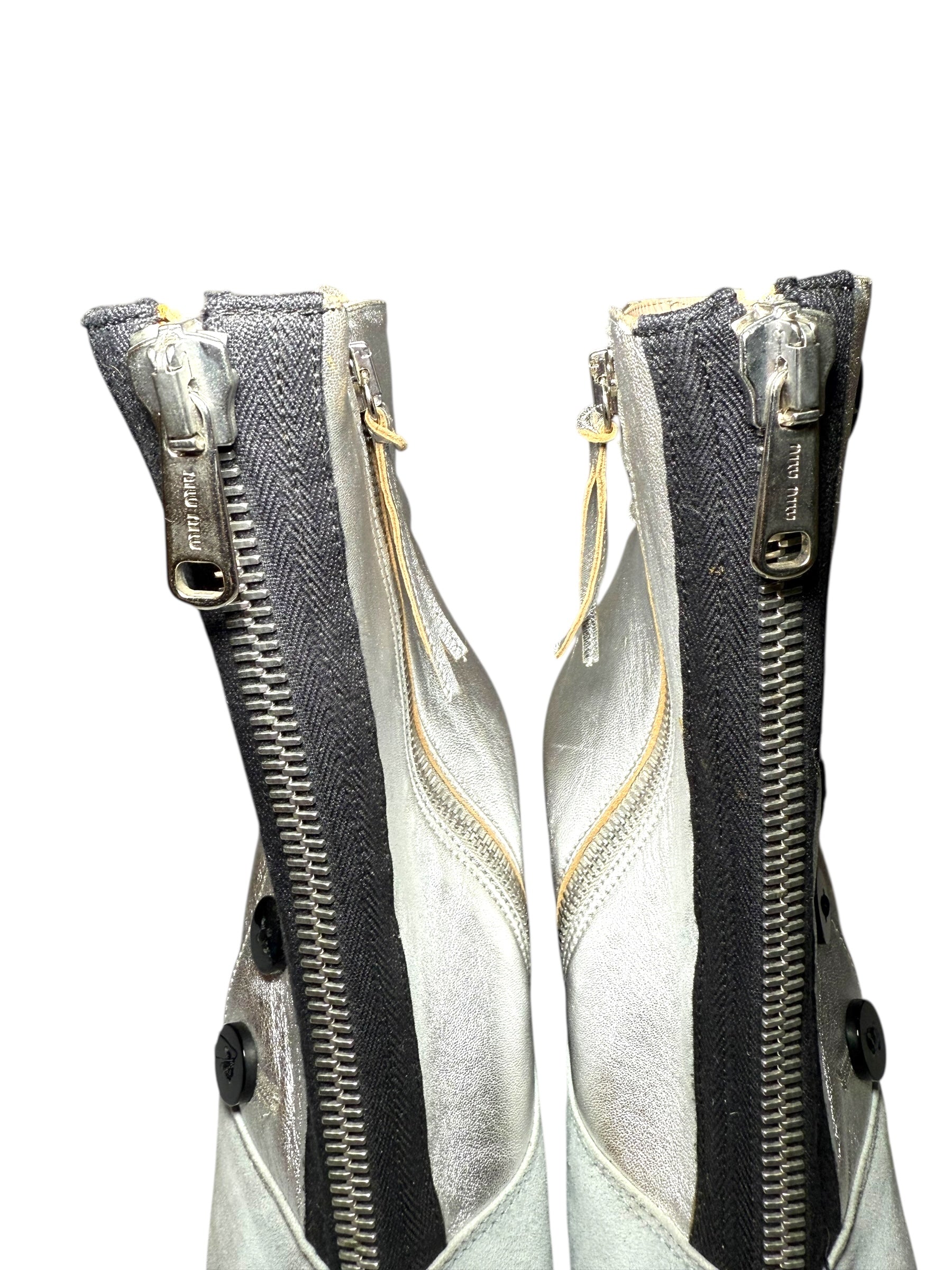 View of Two Miu Miu zipped up ankle booties with a white background