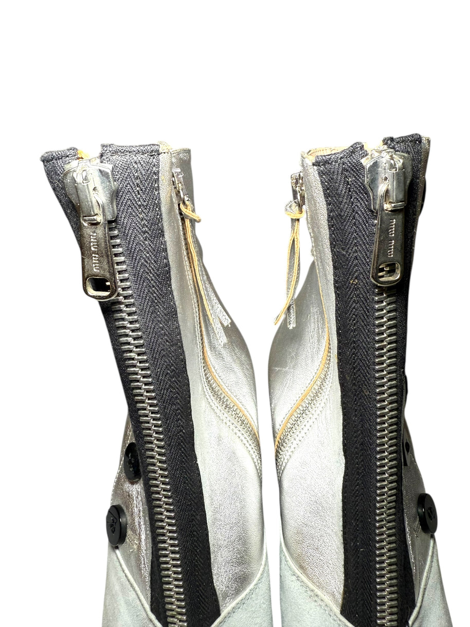 View of Two Miu Miu zipped up ankle booties with a white background