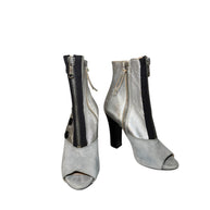 Pair of Miu Miu silver high-heeled boots with zippers on a white background main photo