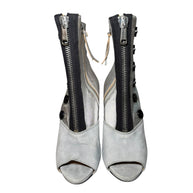 Pair of Miu Miu gray and silver peep-toe booties with zippers on a white background