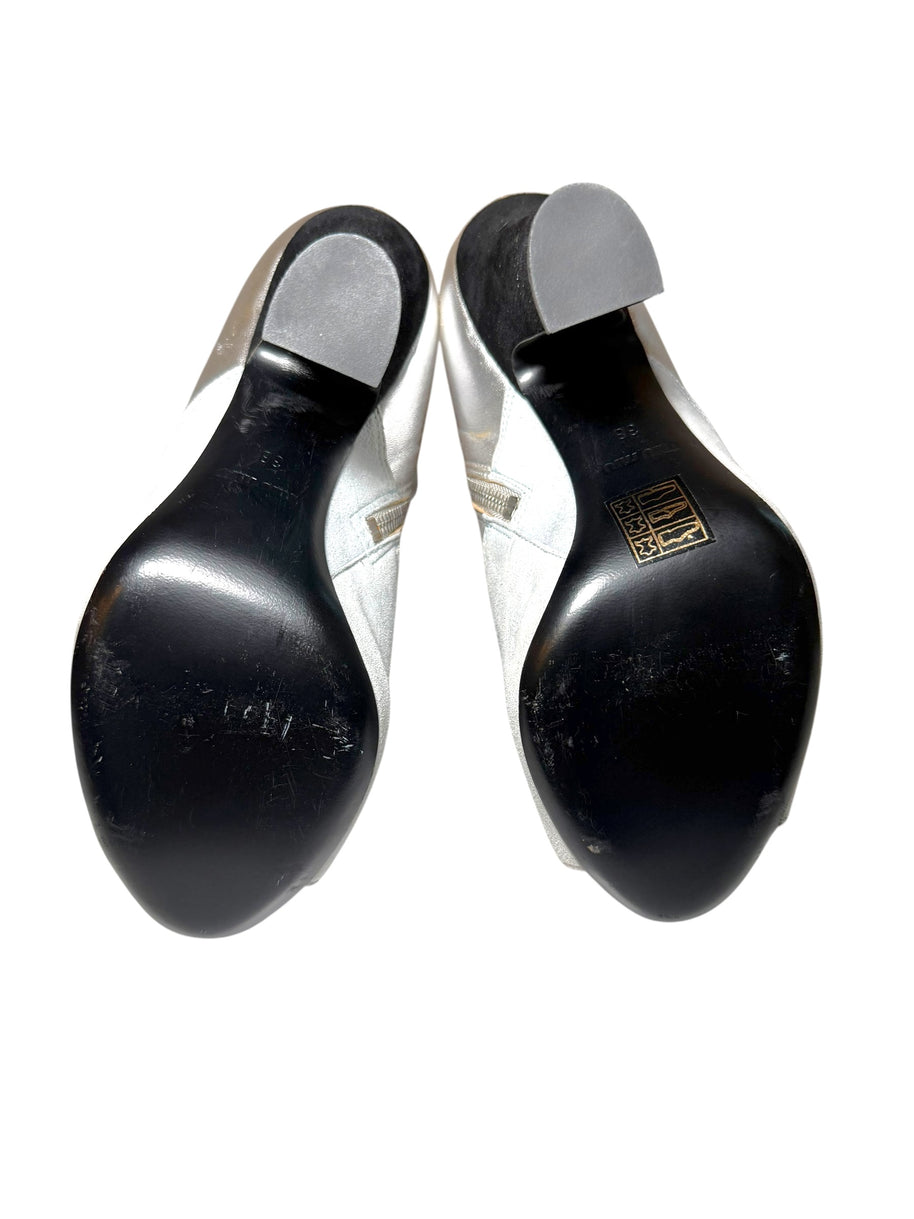 Pair of Silver Miu Miu Ankle Booties with black soles ith a visible Miu Miu brand logo on a white background