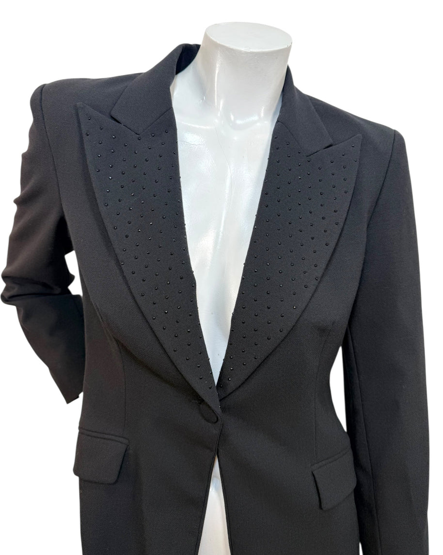 Close-up of Moschino Jeans blazer showing peaked lapels with micro stud embellishments on black wool-blend fabric