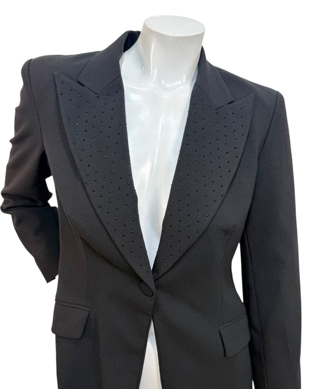 Close-up of Moschino Jeans blazer showing peaked lapels with micro stud embellishments on black wool-blend fabric