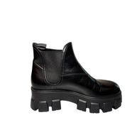 Prada Monolith Left Inside view of Black boot with chunky sole on a white background