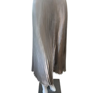 Front view of Prada metallic pleated midi skirt in champagne silver with fluid plissé fabric and black elastic Prada Milano logo waistband.