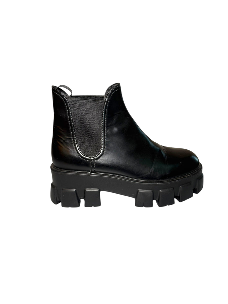 Prada Black leather monolith boot with chunky sole right outside view of right shoe on a white background