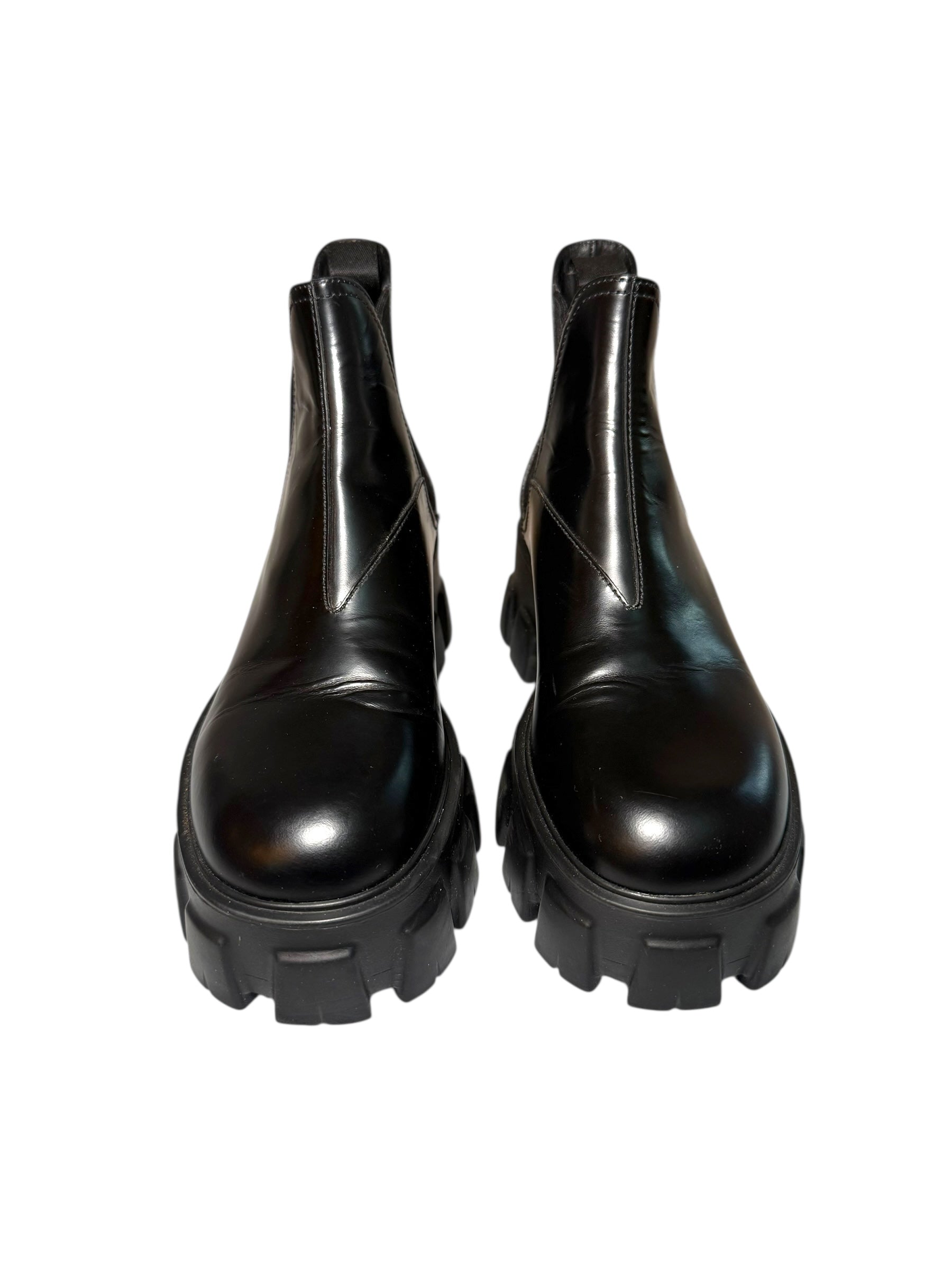 Pair of Prada black platform front view of boots on a white background