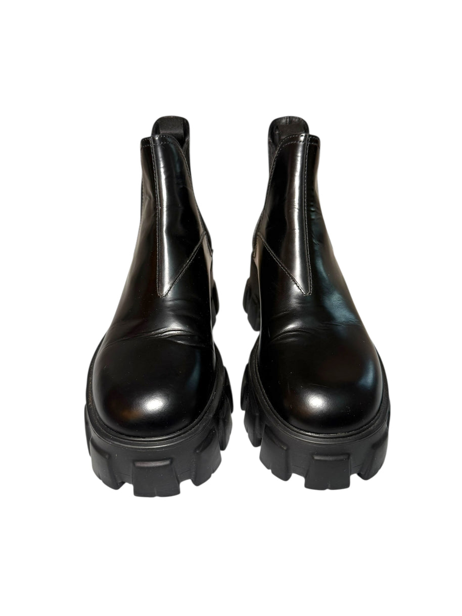 Pair of Prada black platform front view of boots on a white background