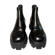 Pair of Prada black platform front view of boots on a white background