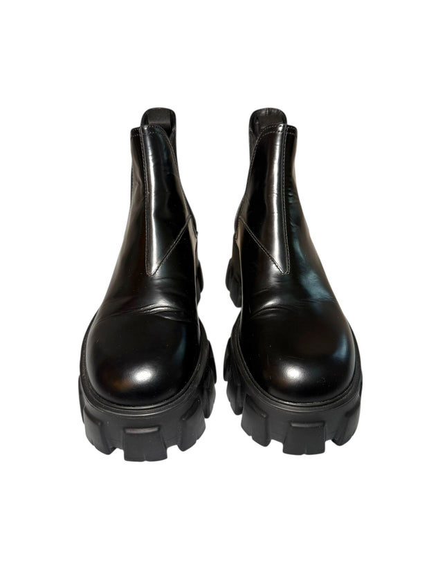 Pair of Prada black platform front view of boots on a white background