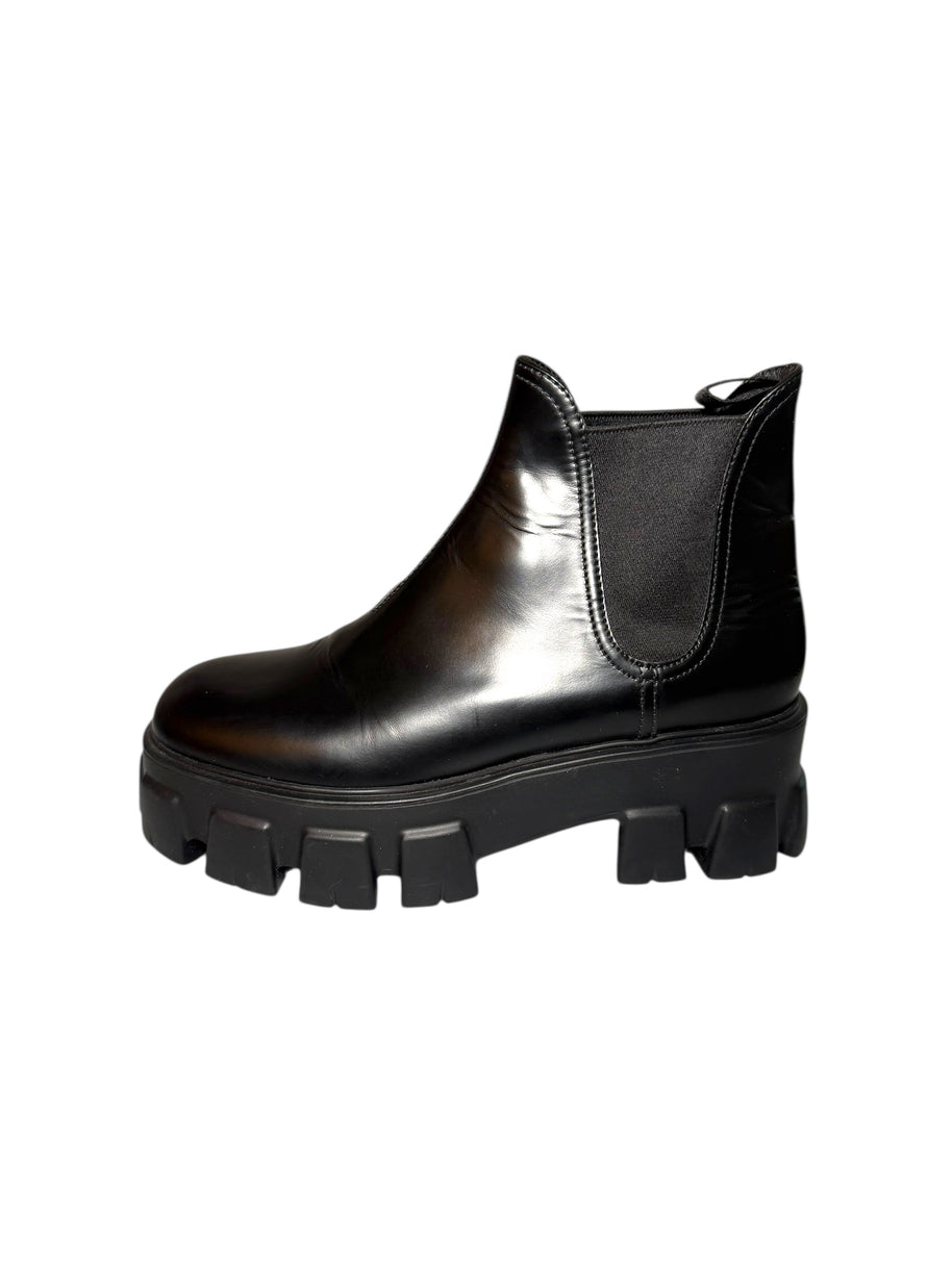 Prada Black leather left chelsea boot with chunky sole on a white background