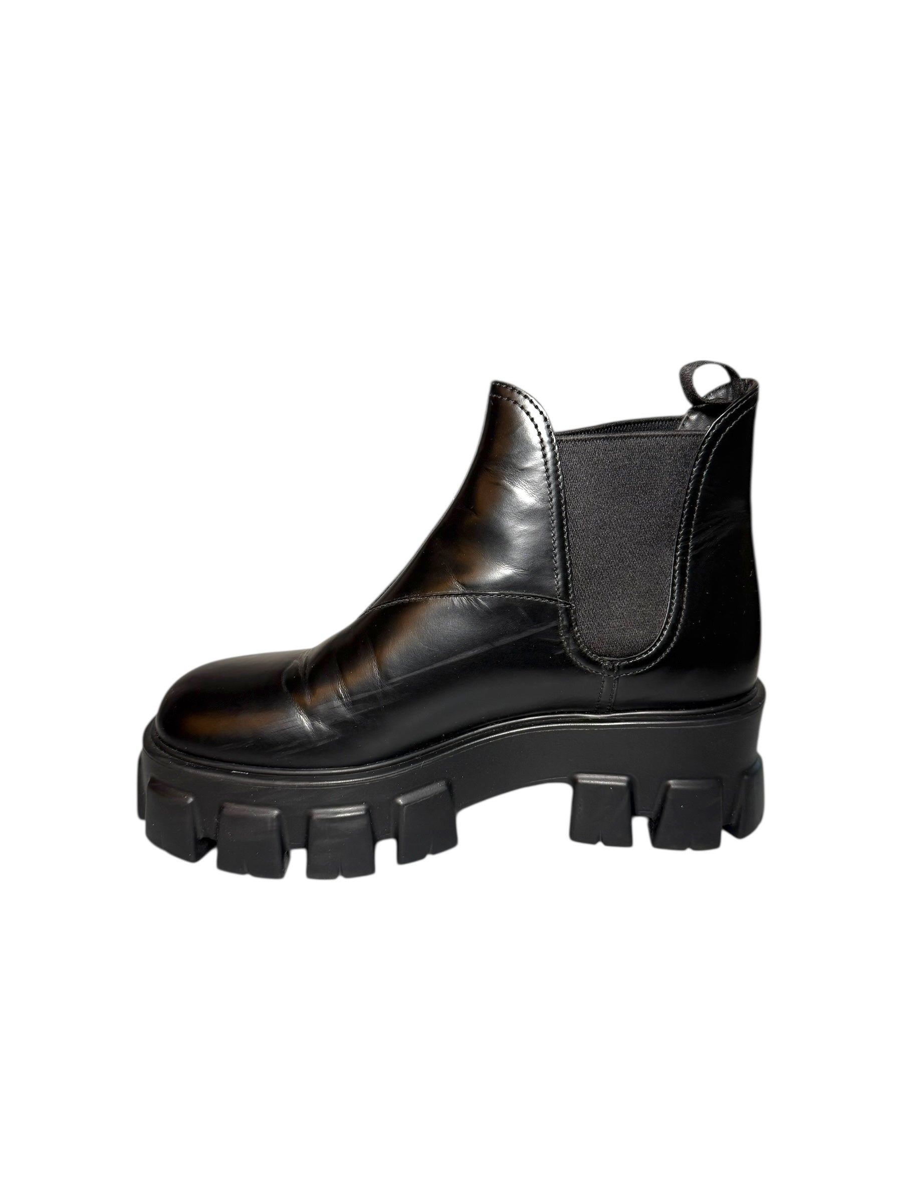 Black Prada leather boot with thick sole right shoe inner side view on a white background