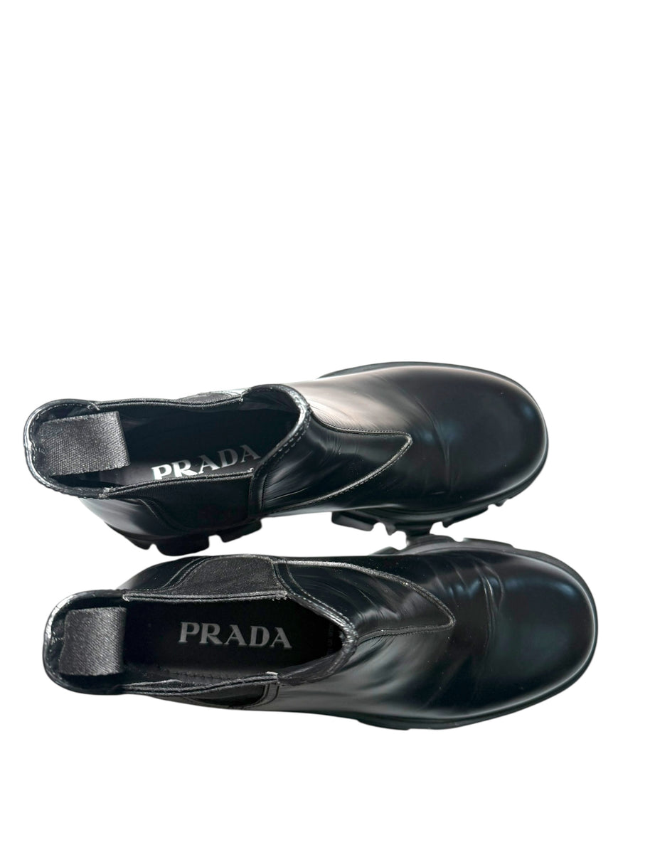 Black Prada shoes showing brand label inside both shoes on a white background