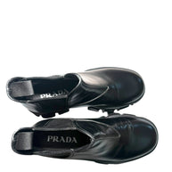 Black Prada shoes showing brand label inside both shoes on a white background