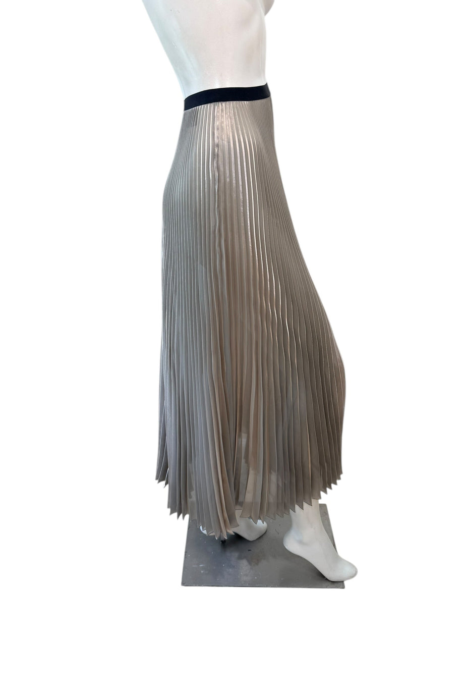 Profile view of Prada metallic pleated skirt highlighting fluid pleats, mid-calf length, and elegant drape.