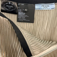 Interior view of Prada metallic pleated skirt showing Prada Milano label, size tag IT 40, and Made in Italy construction.