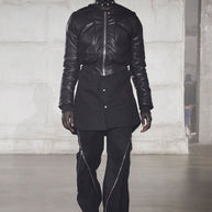 Man wearing a black bomber jacket on the runway for the Rick Owens FW22 Strobe Collection Fashion show in Paris France showcasing the style of the jacket in the listing.