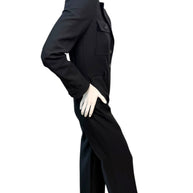 Side angle view of Saint Laurent FW22 black wool jumpsuit showing contoured waist and elongated leg line.