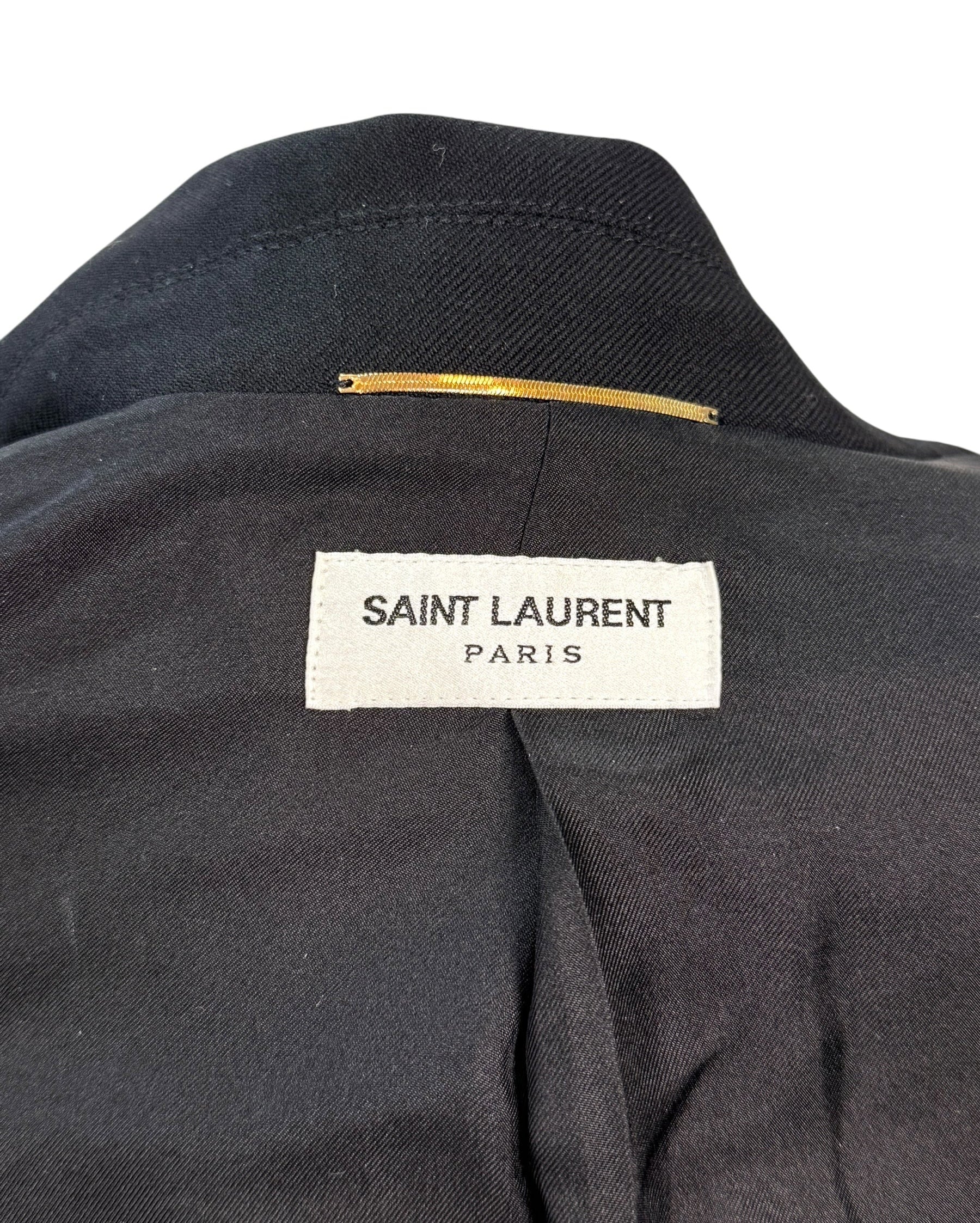 Interior neck label of Saint Laurent Paris black wool jumpsuit confirming designer authenticity.