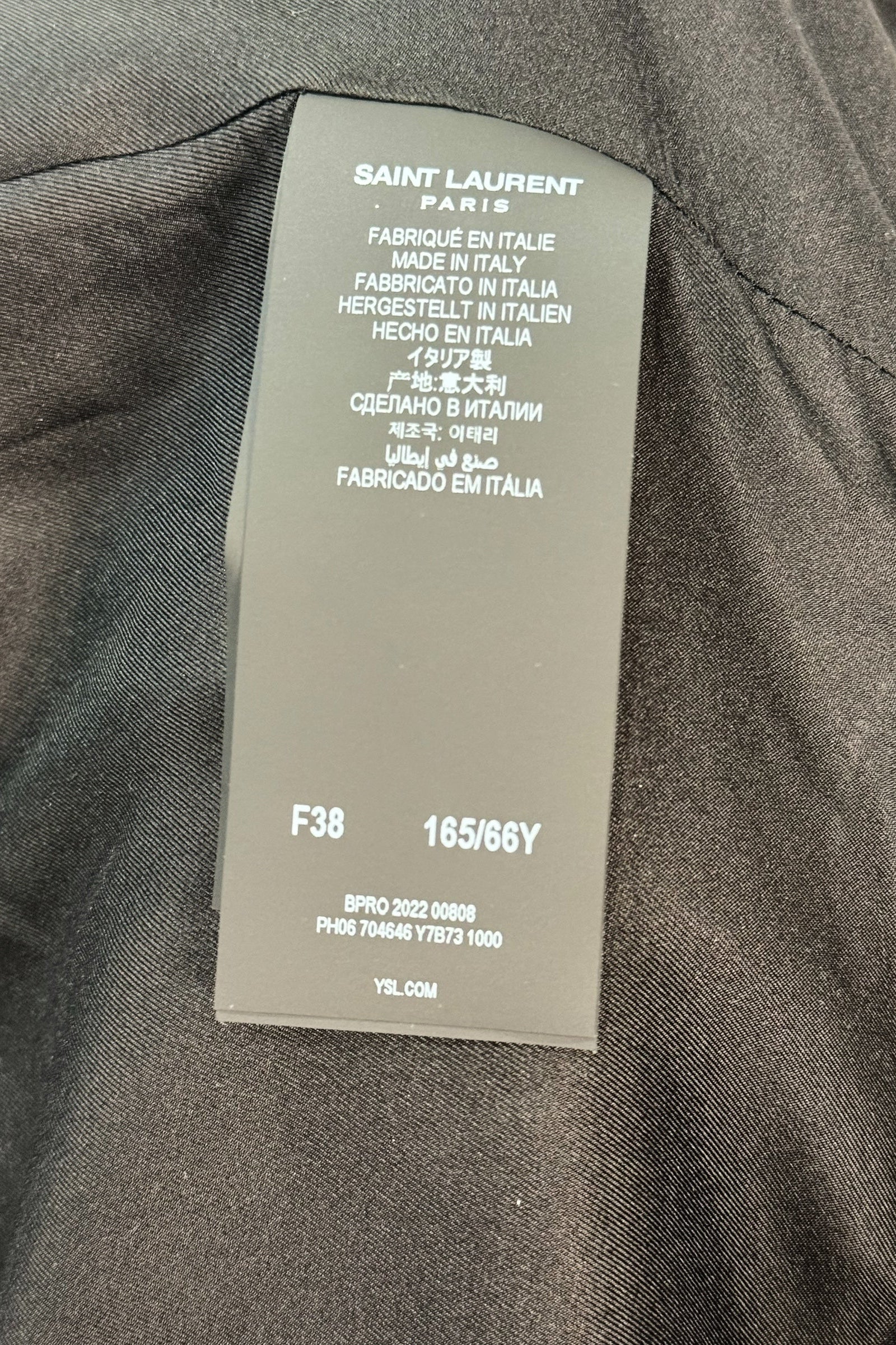 Interior size and production tag of Saint Laurent Paris jumpsuit showing FR 38 and Made in Italy details.