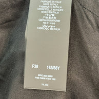 Interior size and production tag of Saint Laurent Paris jumpsuit showing FR 38 and Made in Italy details.