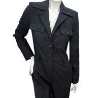 Close front view of Saint Laurent black wool utility jumpsuit highlighting button front, chest flap pockets, and sharp tailoring.
