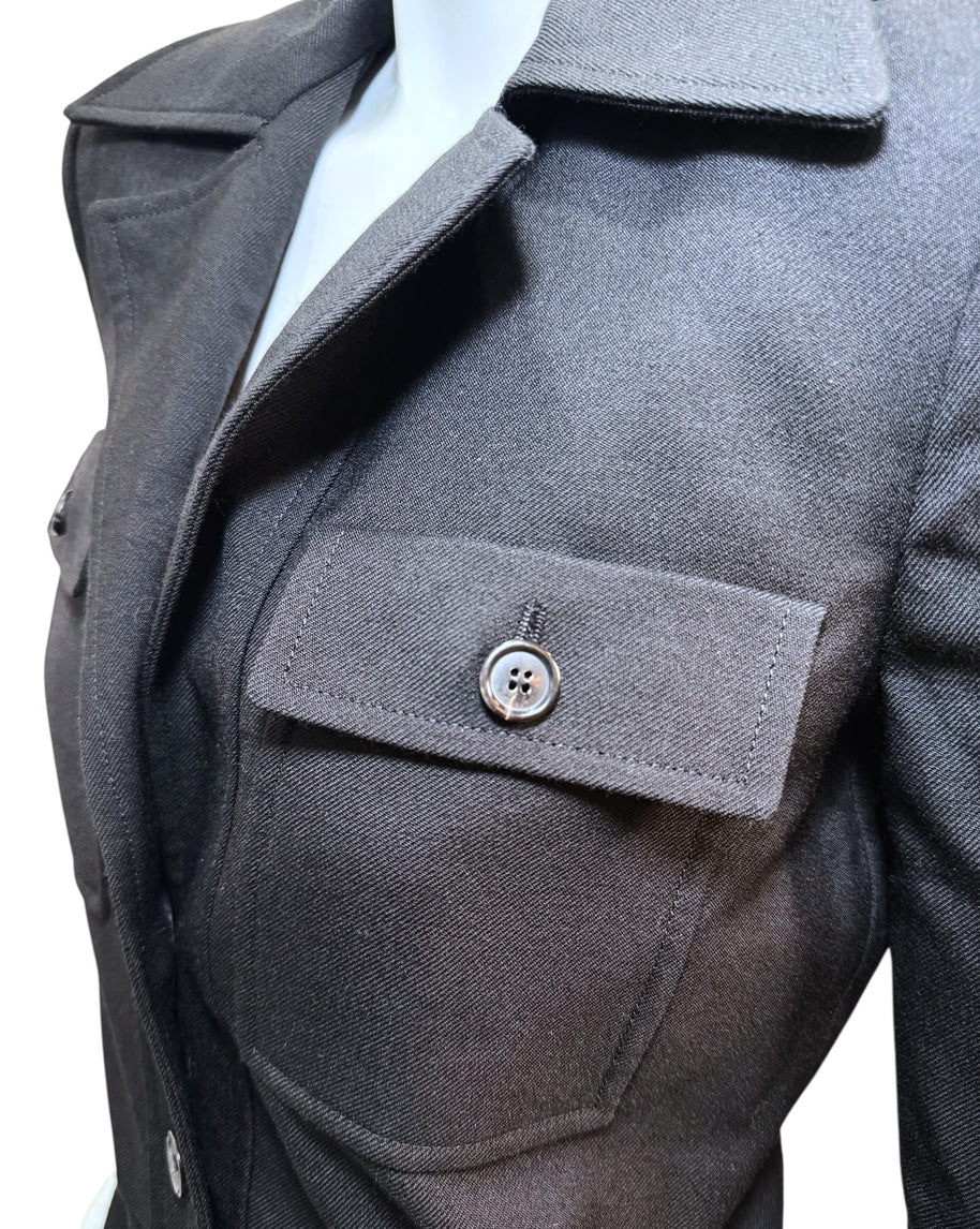 Close-up of Saint Laurent FW22 black wool jumpsuit chest pocket with buttoned flap and precise stitching.