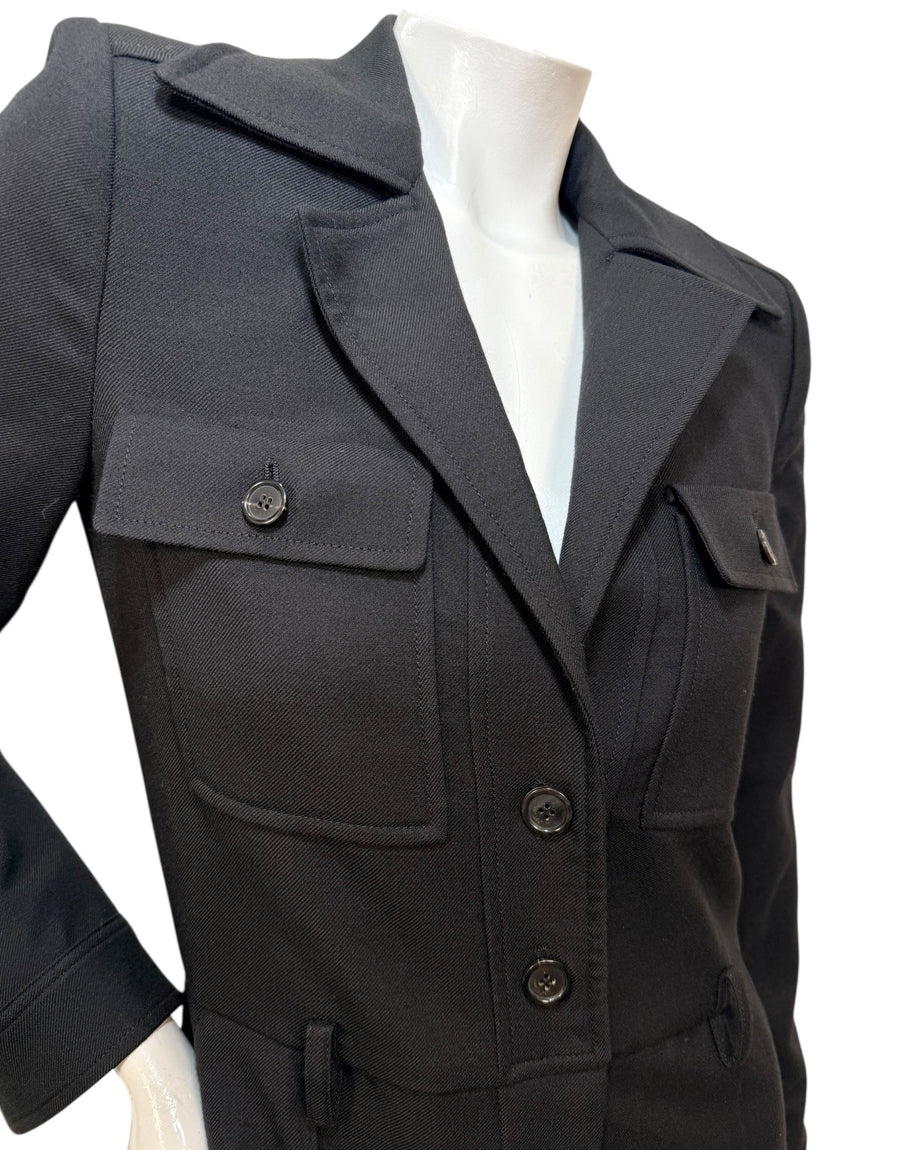 Close-up detail of Saint Laurent Paris black wool fabric showing textured weave and premium tailoring quality.
