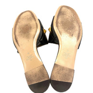 Bottom view of both Valentino Roman Stud Slides showing gold-stamped branding and Italian craftsmanship.