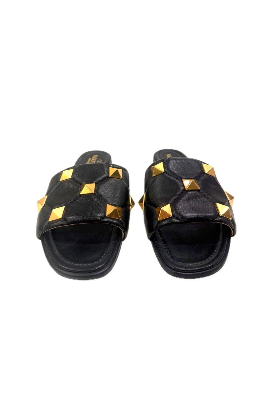Front view of Valentino Garavani Roman Stud flat slides in black Nappa leather with gold studs.